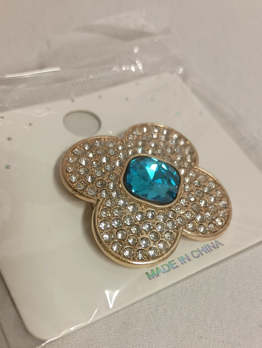 Gold Tone Rhinestone Flower Brooch Pin with Iridescent Crystal Center Blue